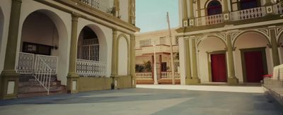 a building with a red door and a white railing