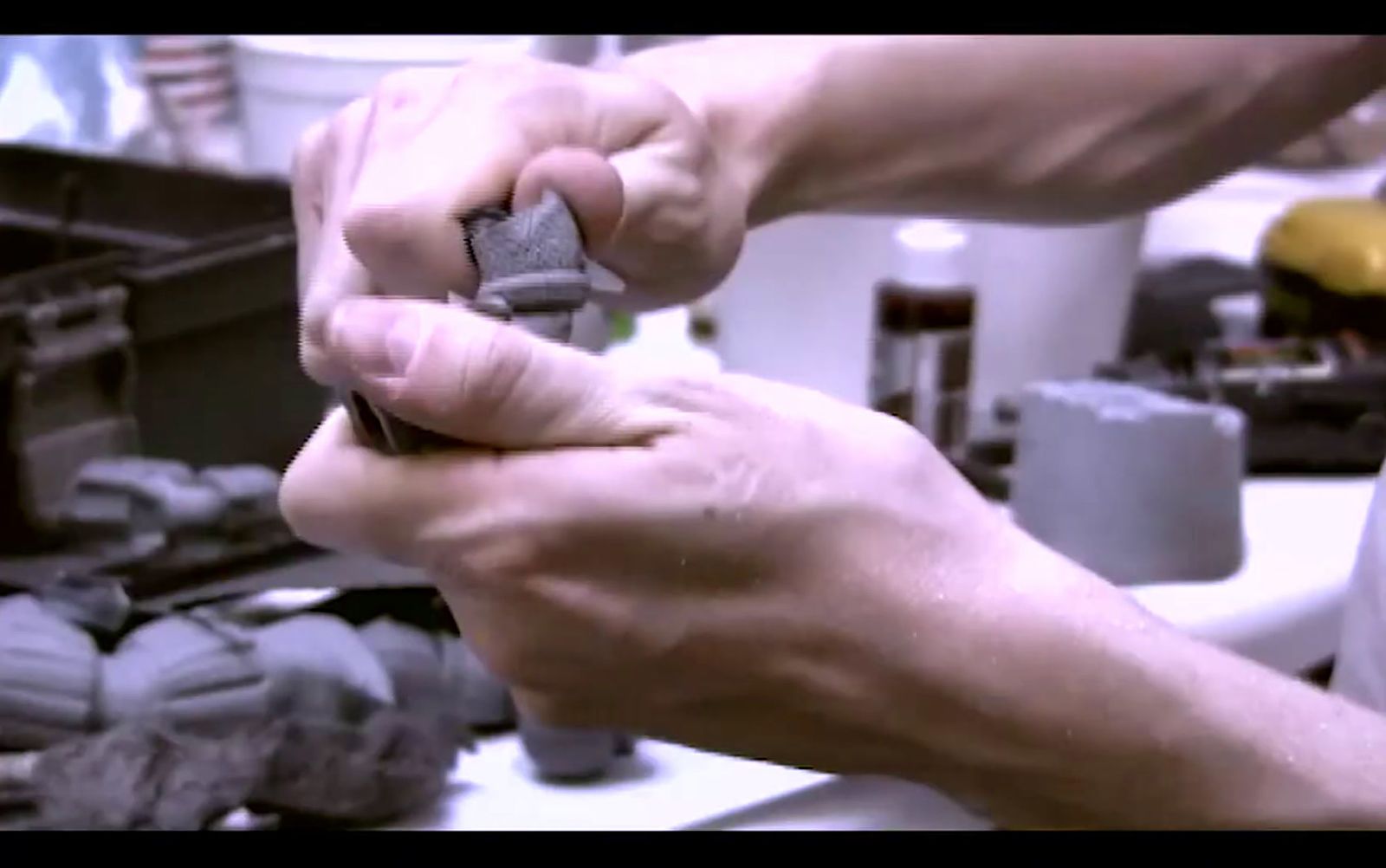 a man is working on a piece of metal