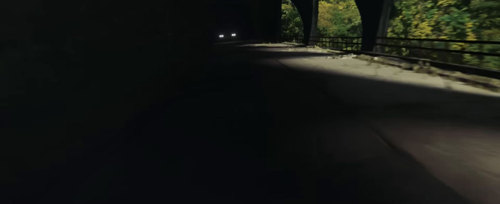 a car driving through a tunnel in the dark