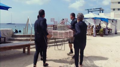 a group of people standing next to each other on a beach