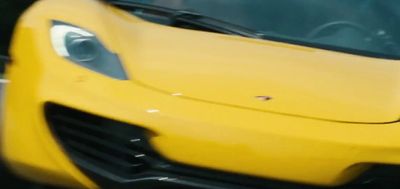 a close up of a yellow sports car