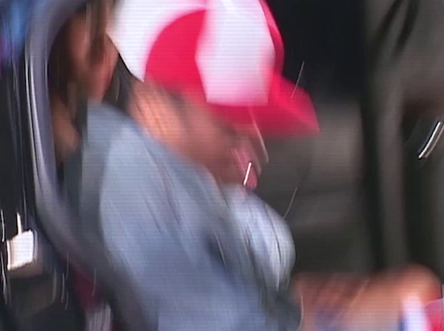 a blurry photo of a man wearing a red and white hat