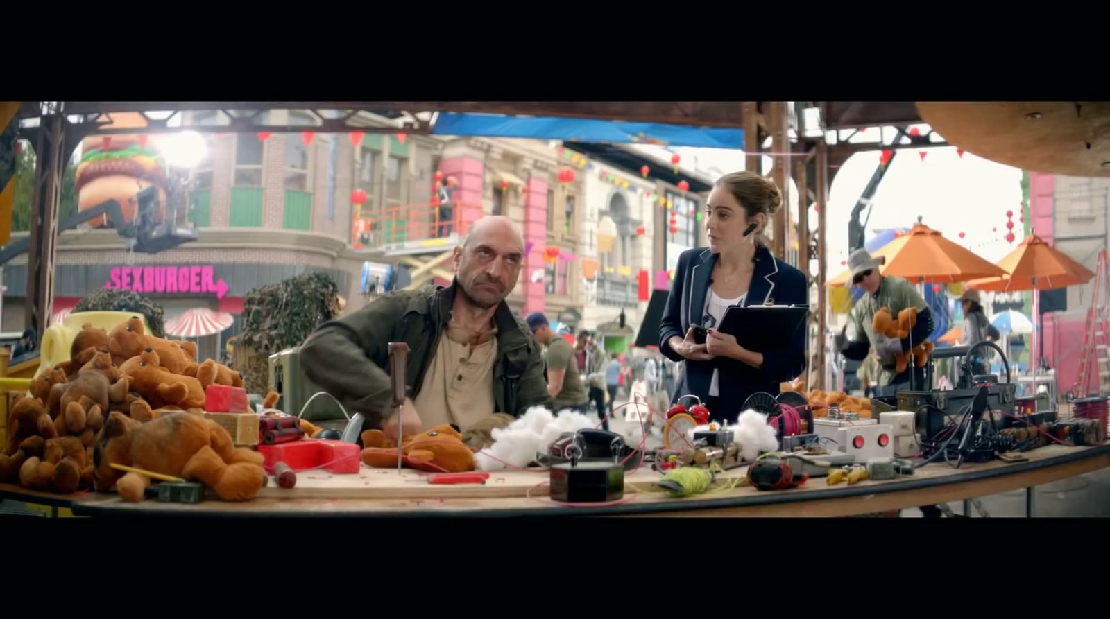 a man and a woman standing at a table with food