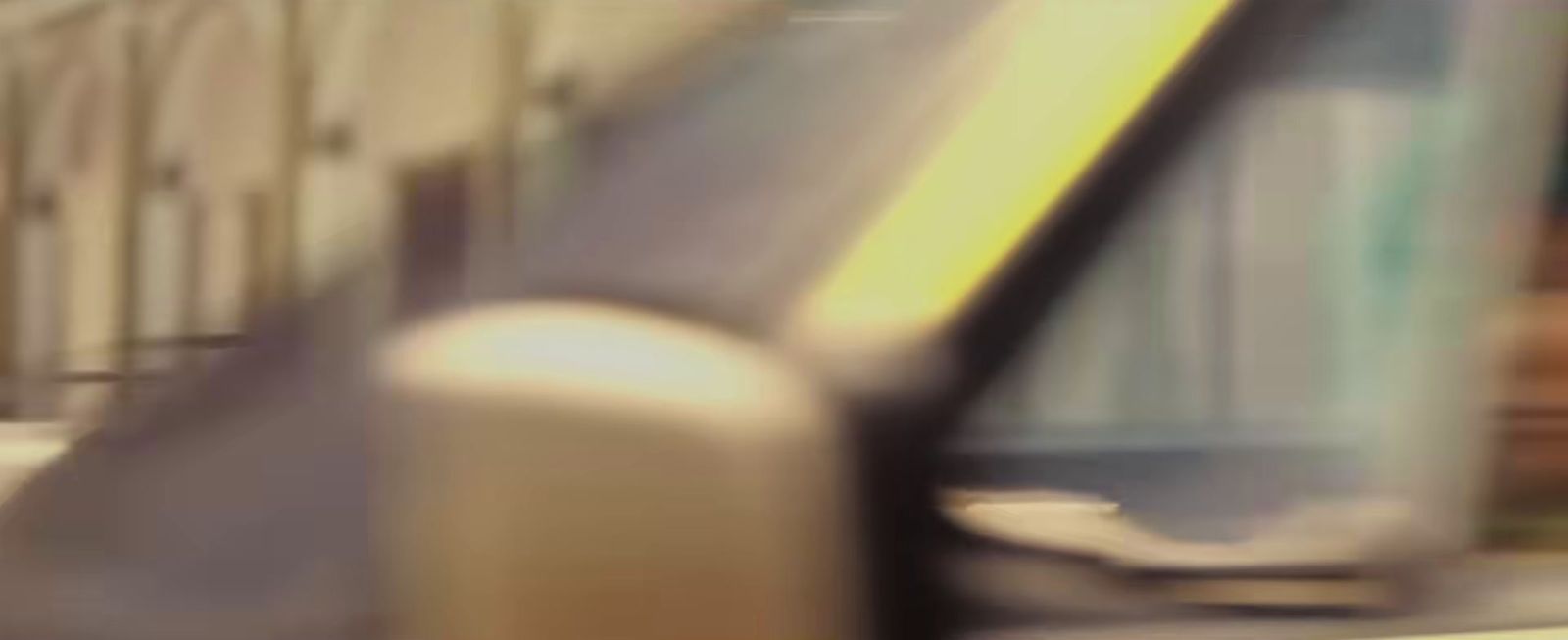 a close up of a car mirror with a building in the background