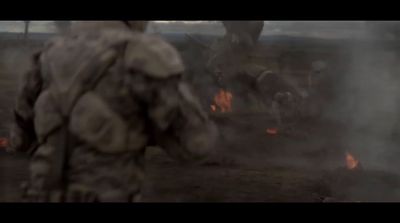 a man standing in front of a fire filled field