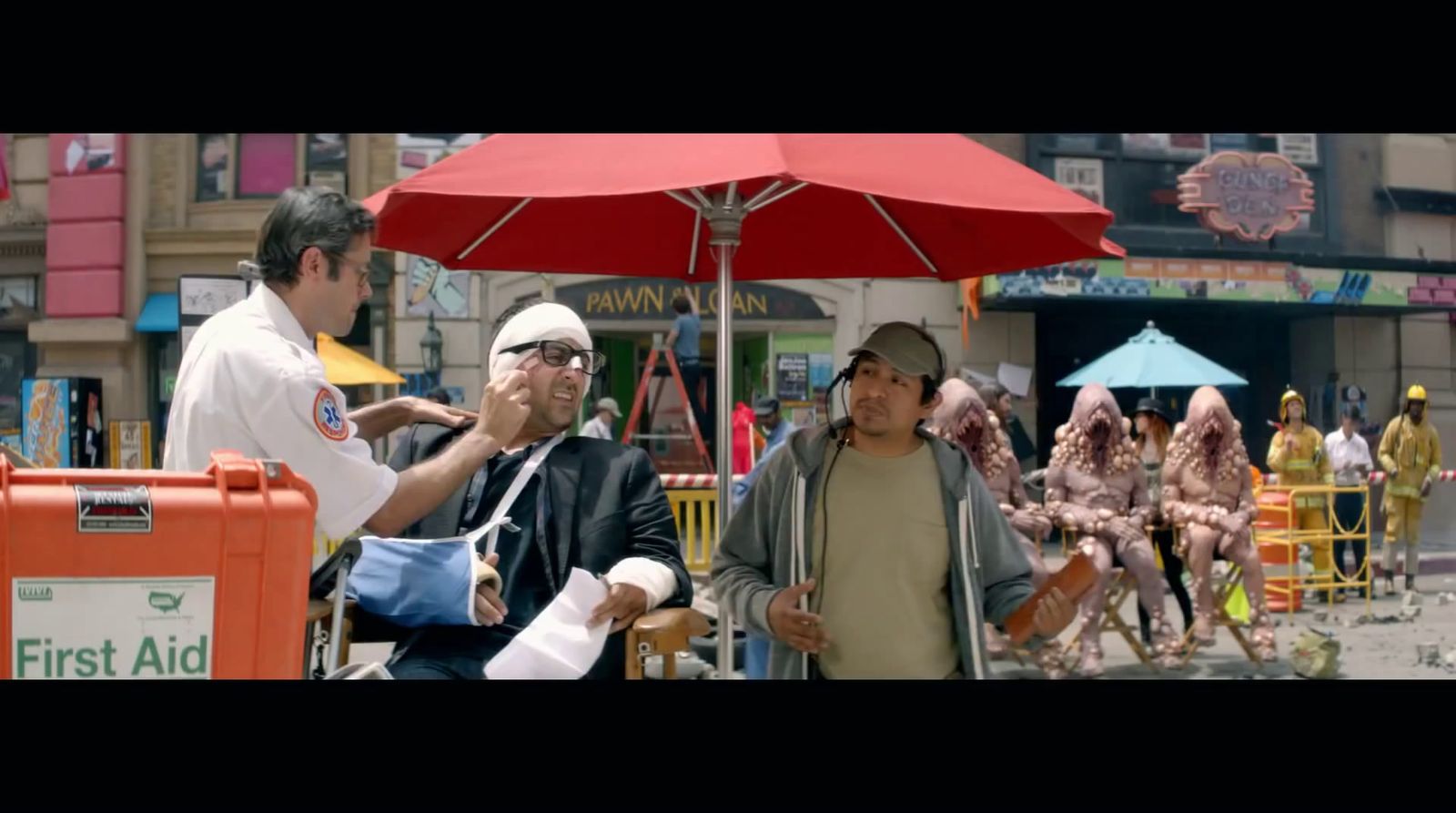 a group of people standing under a red umbrella