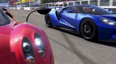 a blue and red sports car driving down a race track