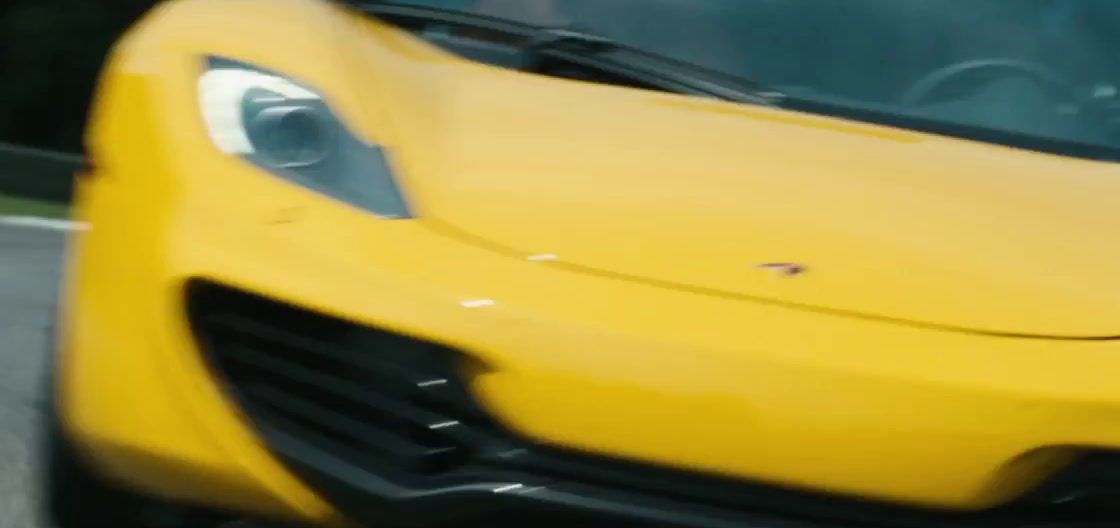 a close up of a yellow sports car