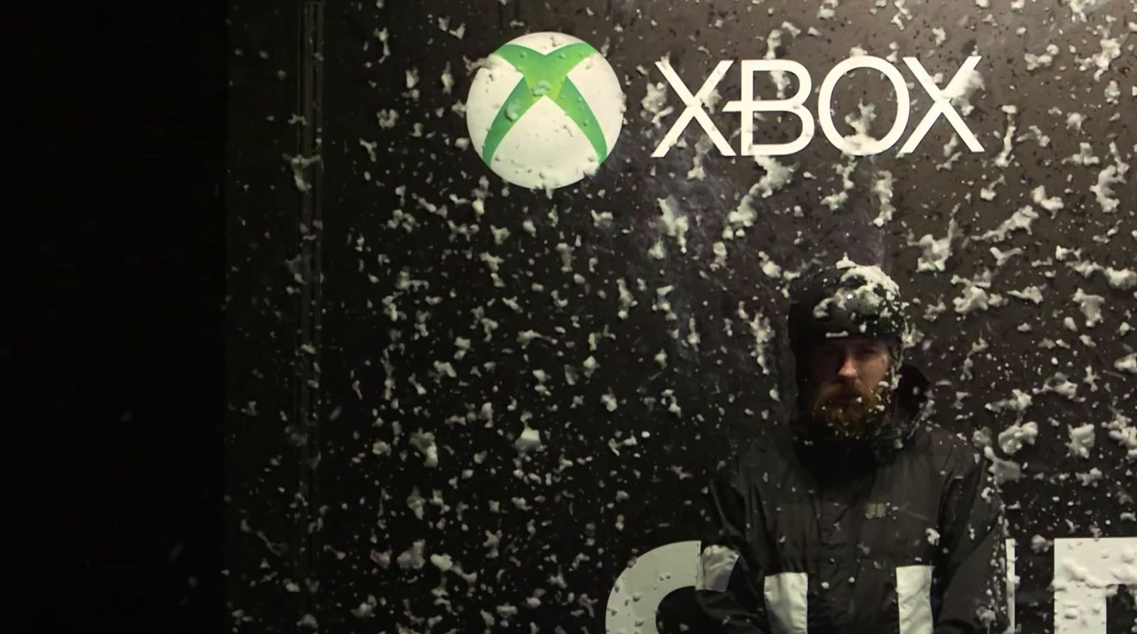 a man standing in front of a xbox logo