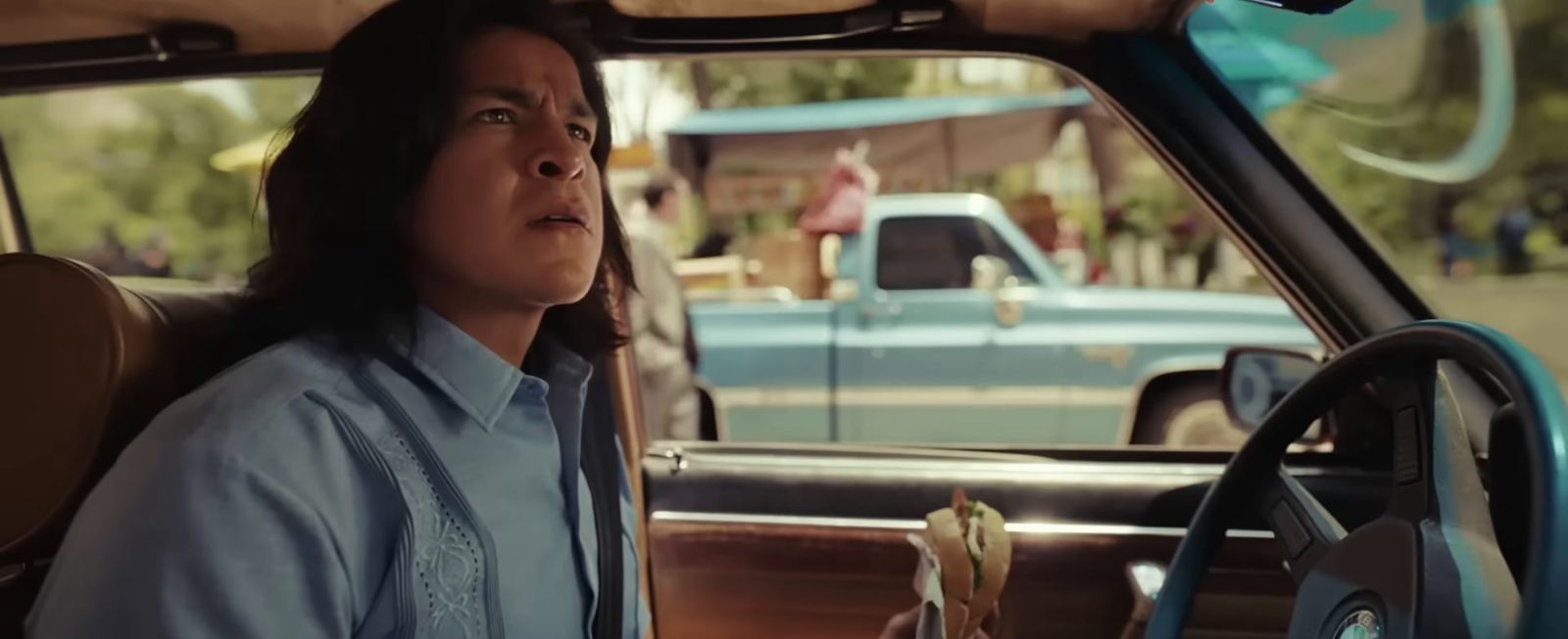 a woman sitting in the driver seat of a car