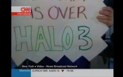 a person holding a sign that says it is over halo3