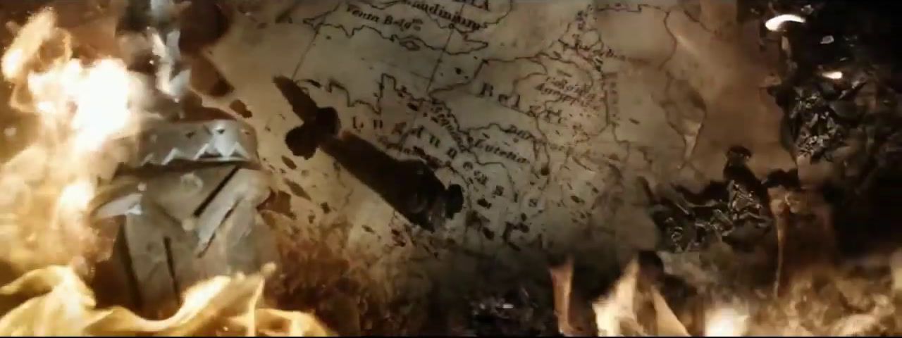 a fire burning in a room with a map on the wall