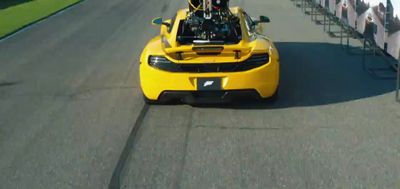 a yellow sports car driving down a race track