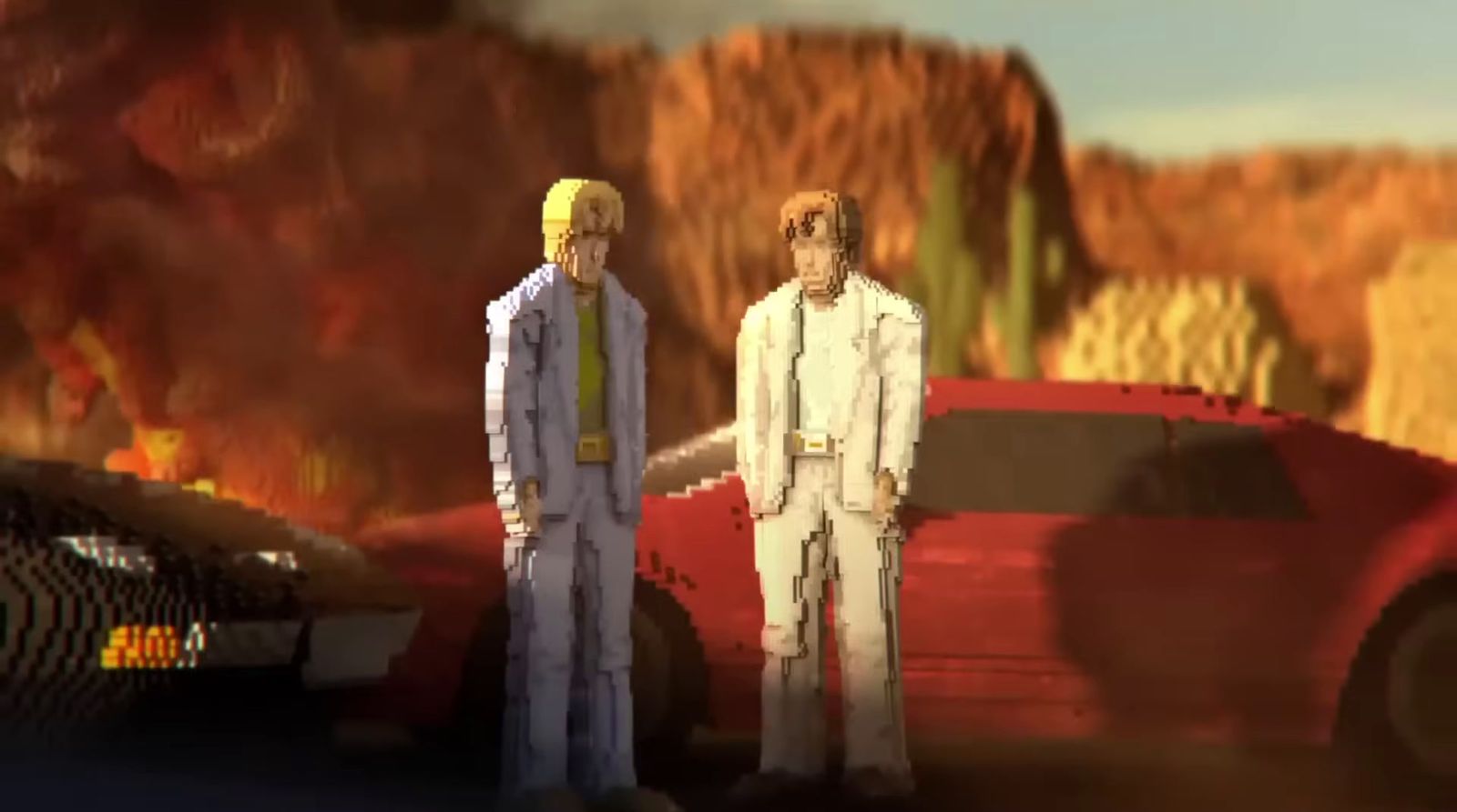 two men standing next to each other in front of a red car