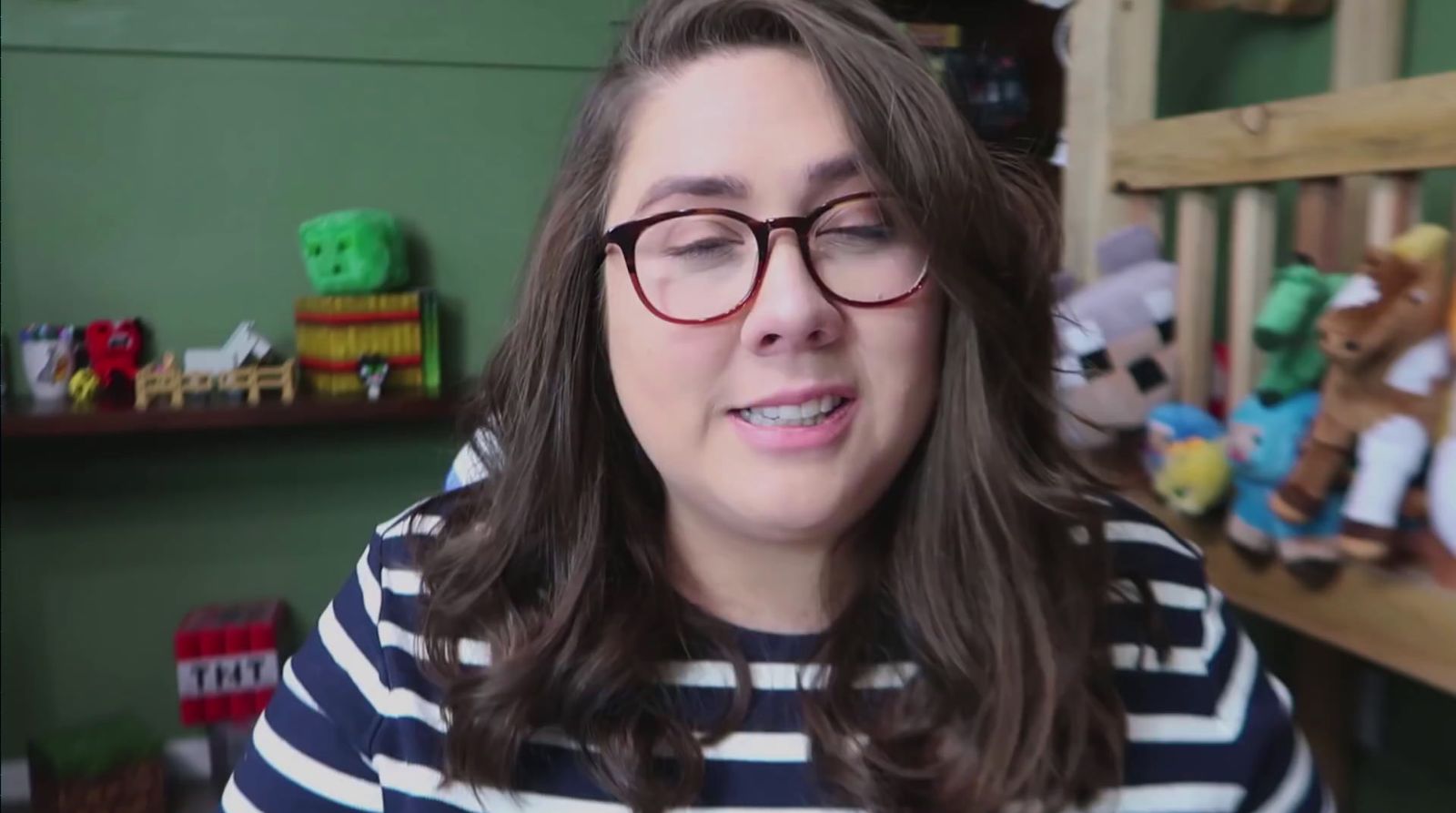 a woman wearing glasses and a striped shirt