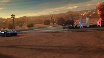 a blue car driving down a road next to a desert