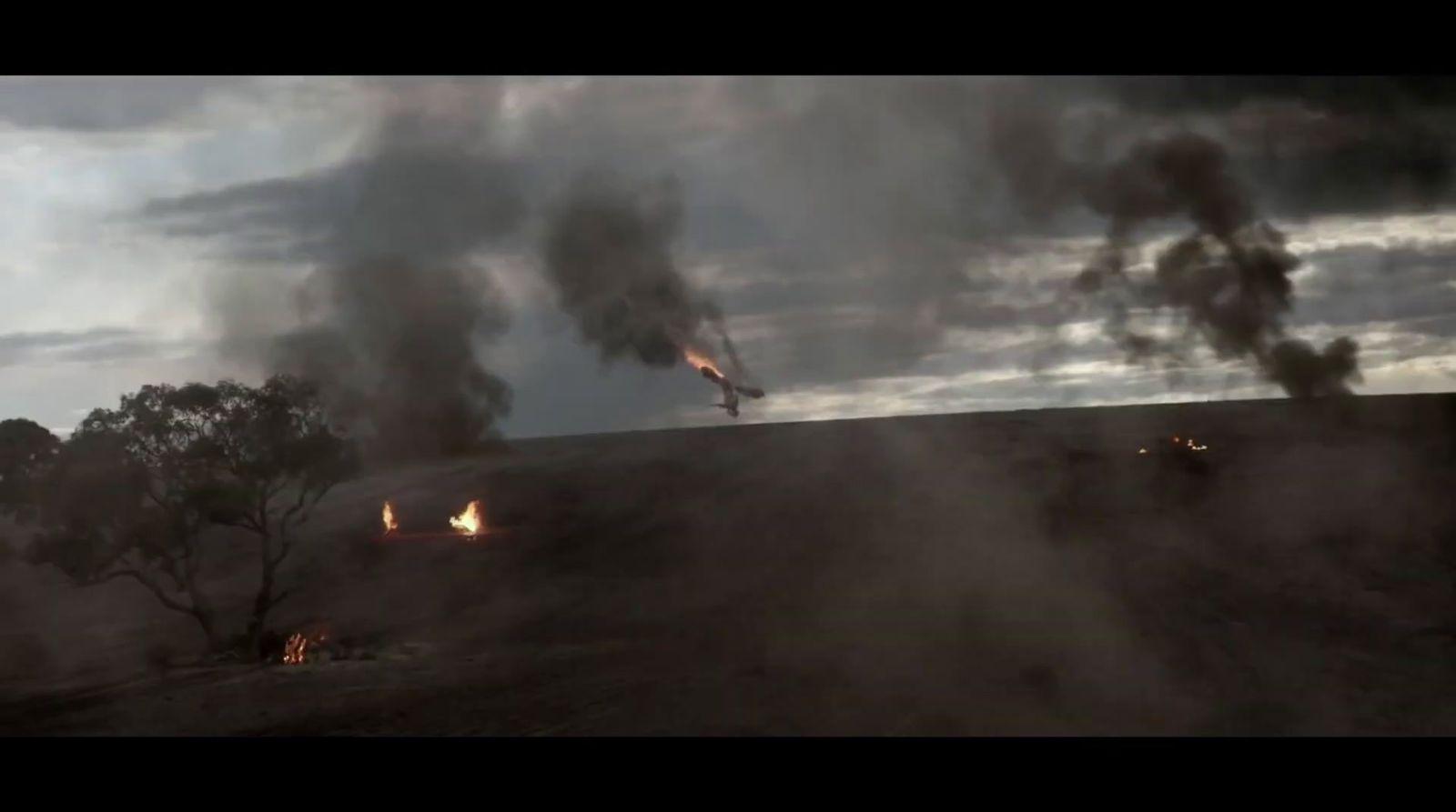 a plane is flying over a field of smoke