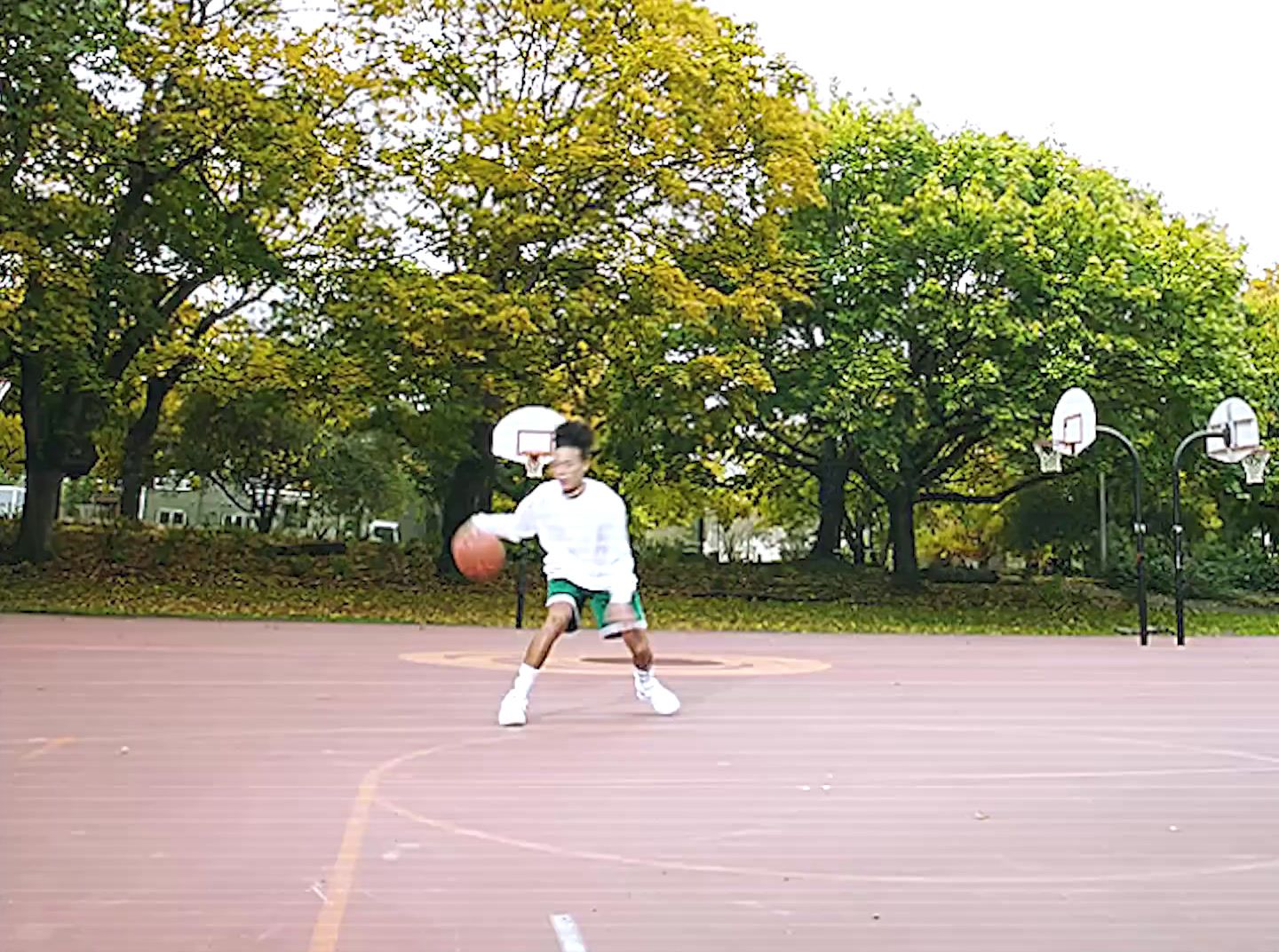 a man standing on a basketball court holding a basketball