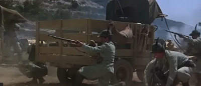 a group of men with guns in front of a truck