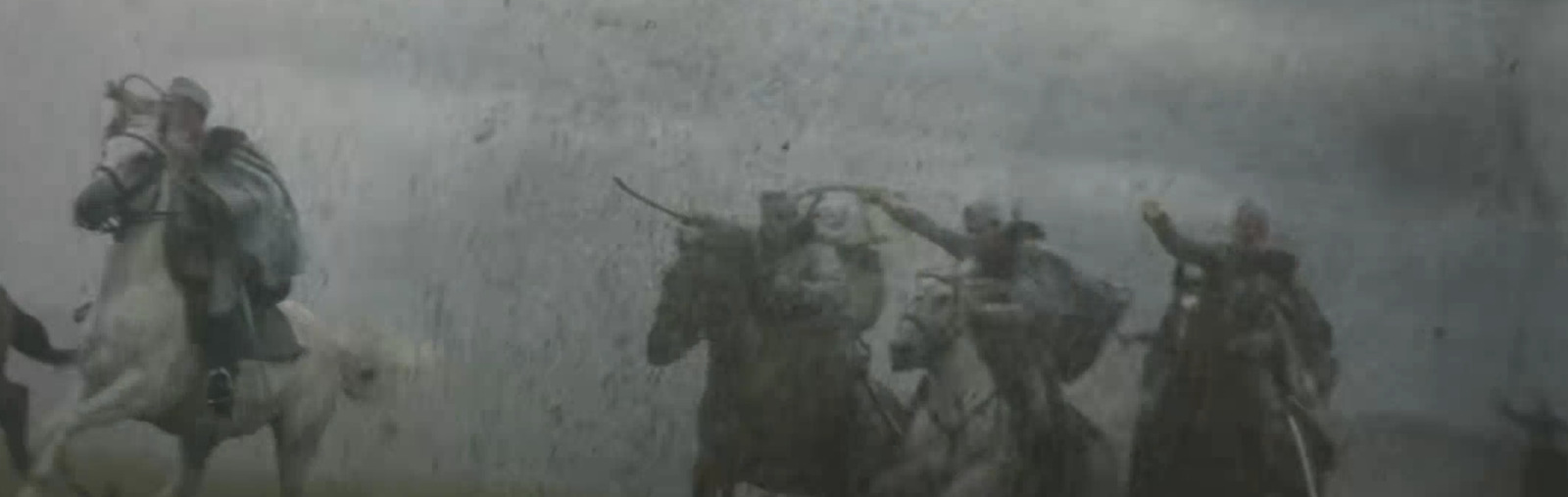 a group of people riding horses in the rain