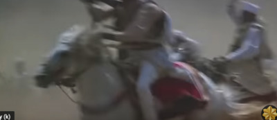 a blurry image of a man riding a horse