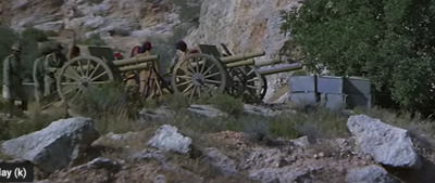 a group of people riding on top of a wooden cart