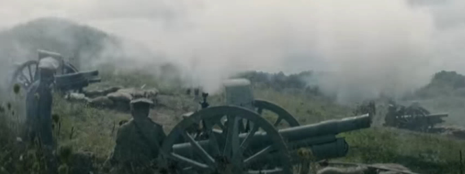 a group of men standing next to each other near a cannon