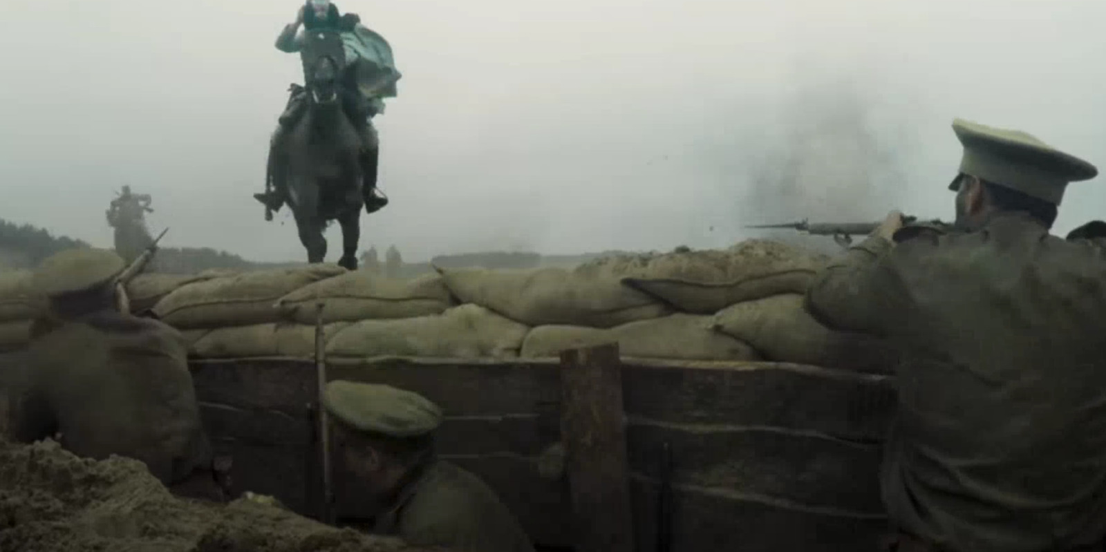 a man riding on the back of a horse next to a pile of sand