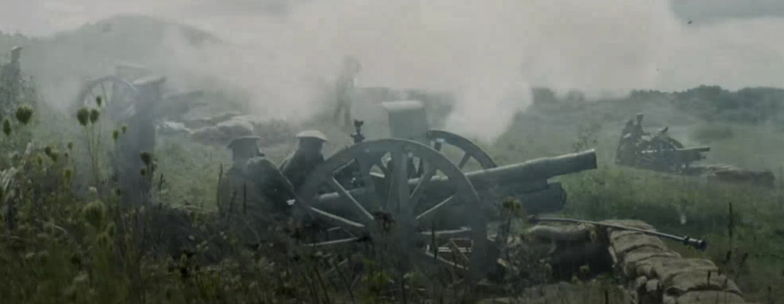 a group of men standing next to a cannon