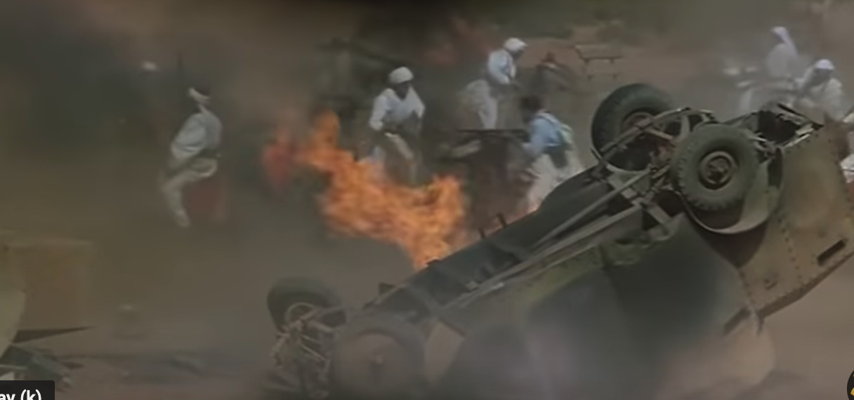 a group of men riding on the back of a truck