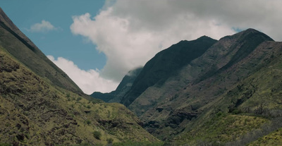 a view of a mountain range with a cloudy sky