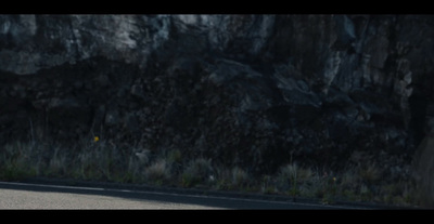 a man riding a motorcycle down a curvy road