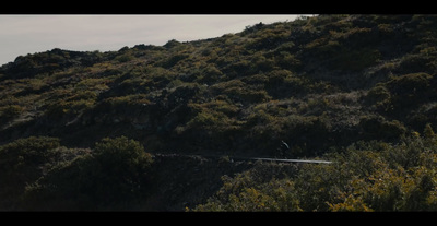 a man riding a snowboard down the side of a mountain