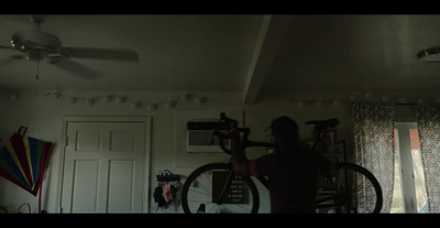 a person standing in a room with a bike