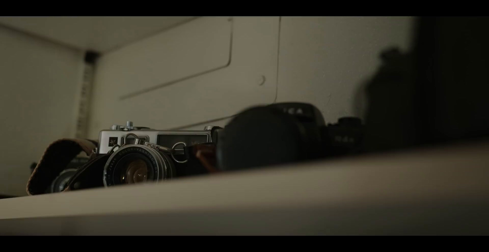 a camera sitting on top of a table next to a mirror