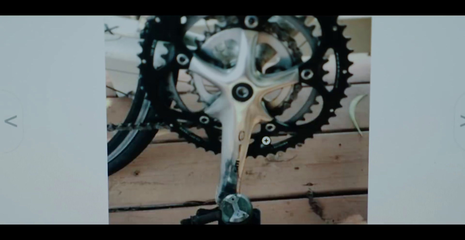 a close up of a bike's gear on a wooden floor