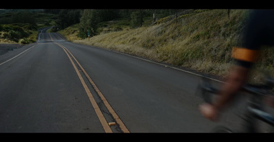 a man riding a bike down a curvy road