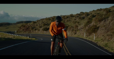 a man riding a bike down a curvy road