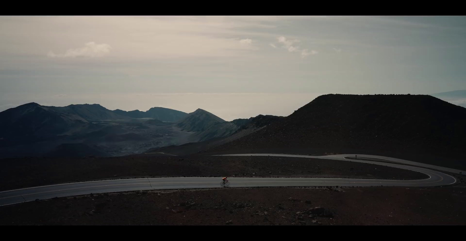 a person riding a bike down a curvy road