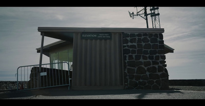 a small building with a metal fence around it