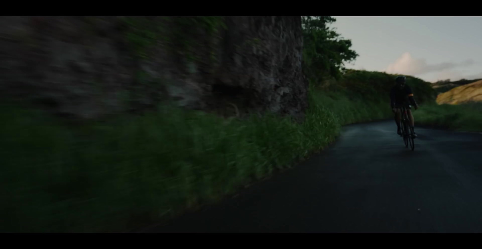 a blurry photo of a person riding a bike down a road