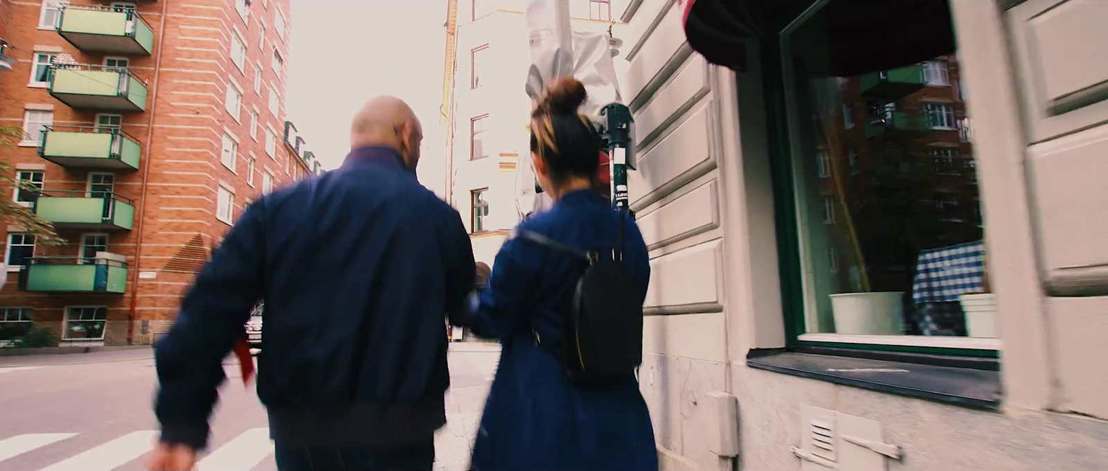 a man and a woman walking down a street