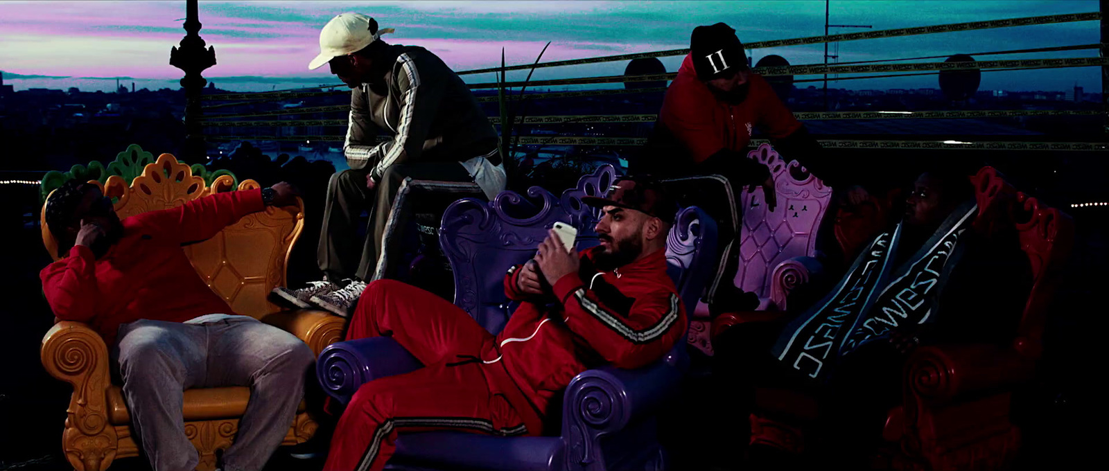 a group of people sitting on top of colorful chairs