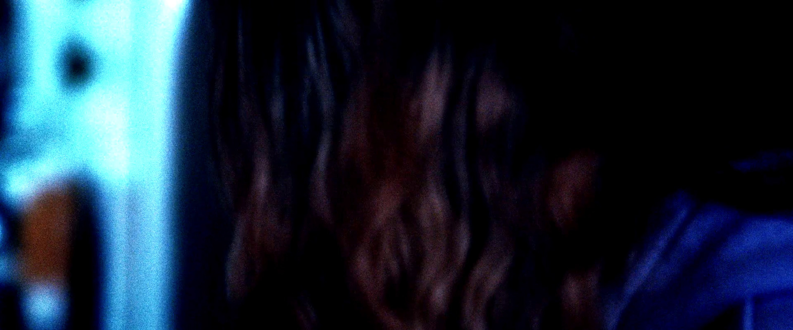 a blurry photo of a woman with long hair