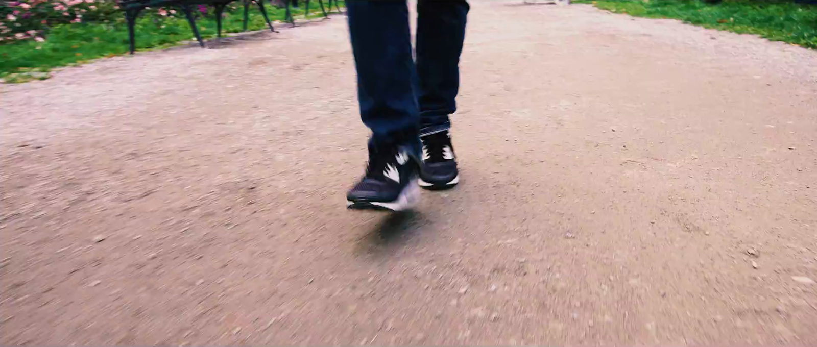 a person riding a skateboard down a dirt road