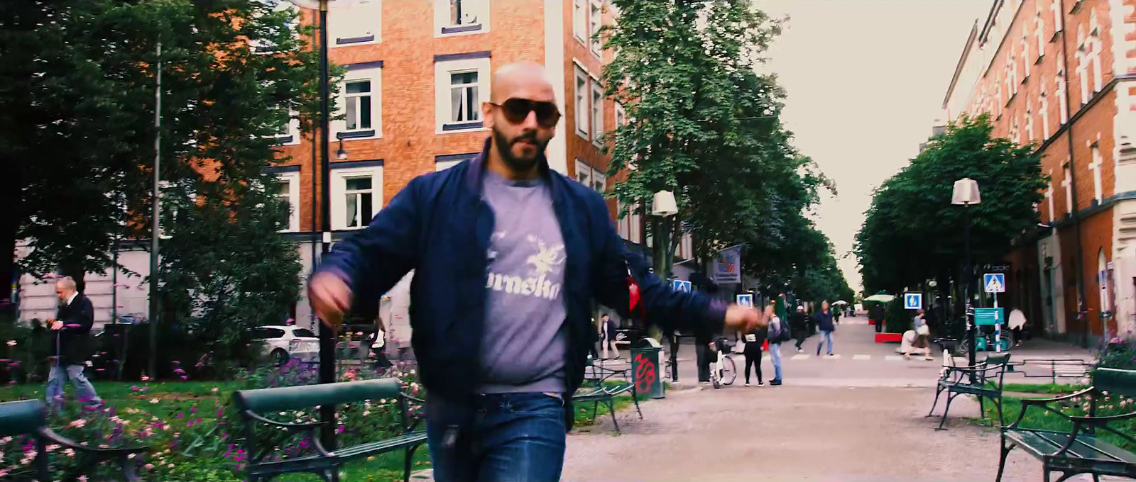 a man walking down a sidewalk in a city