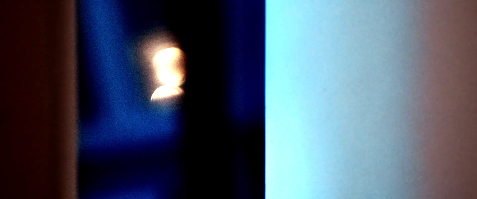 a blurry photo of a candle in a room