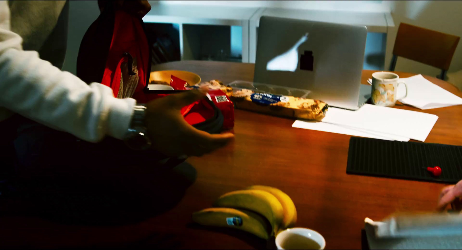 a person sitting at a table with a laptop