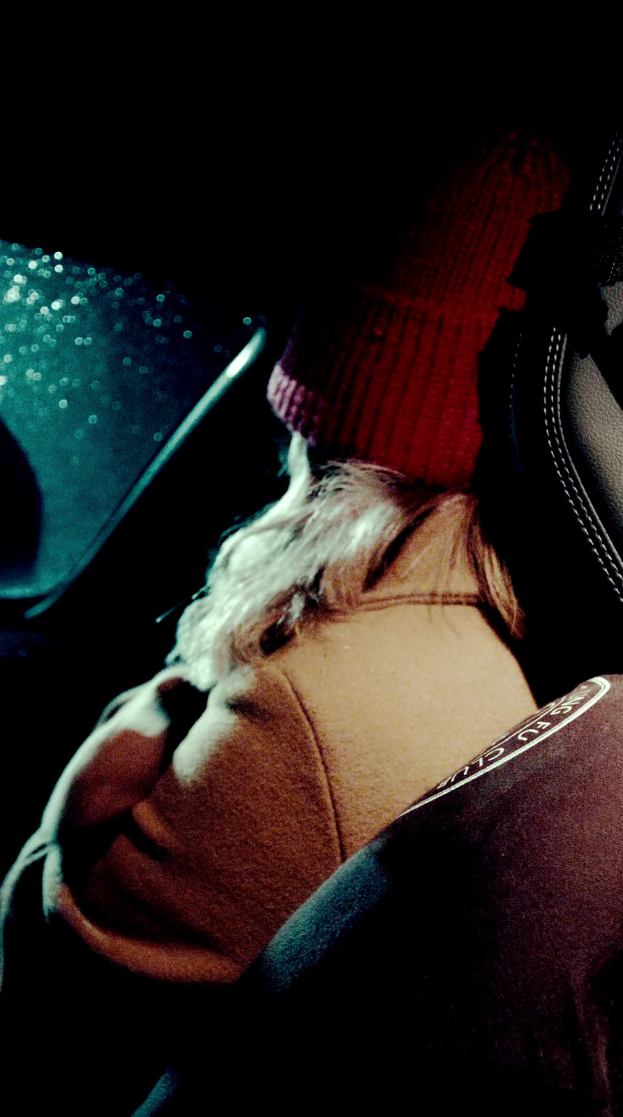 a person wearing a red hat sitting in a car