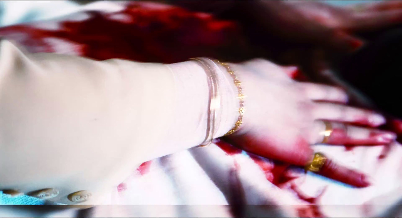 a person wearing a white glove with blood on it